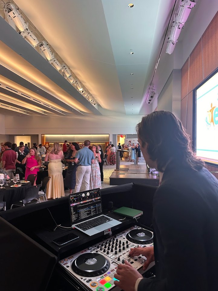 A Nightbird DJ at the controller during a corporate cocktail hour in a north Georgia ballroom