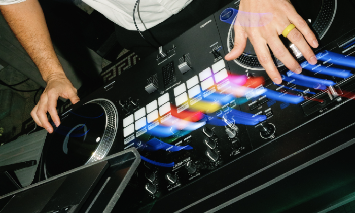 A Nightbird DJ working the decks mid-set, photo by Anna Ray Photography