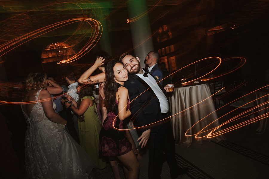 Light trails over a packed dance floor in party mode at a downtown Athens wedding reception