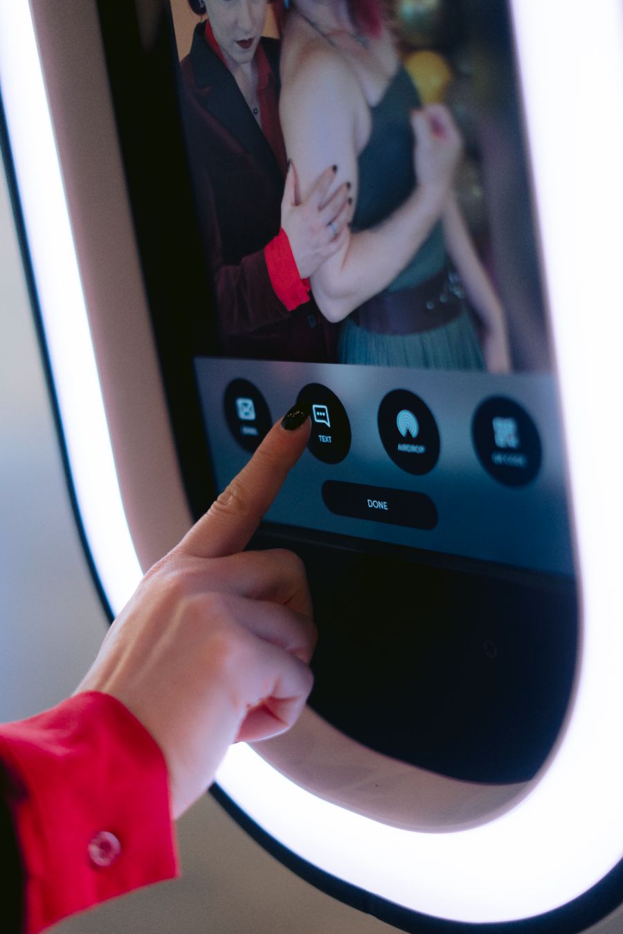 A guest texting the photo to themselves from the booth screen