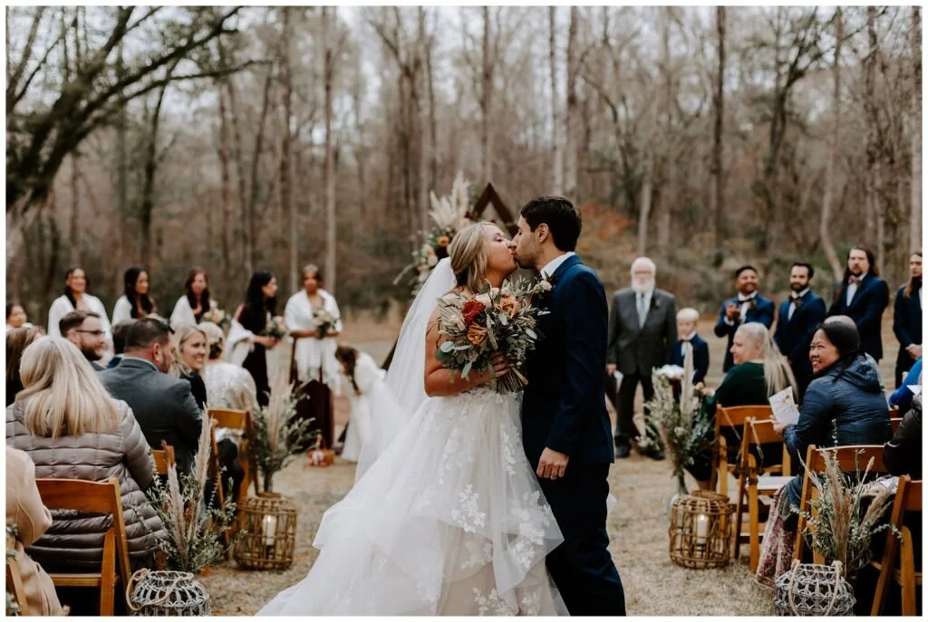 Couple kissing at the end of an outdoor ceremony at The 62, Madison, Georgia