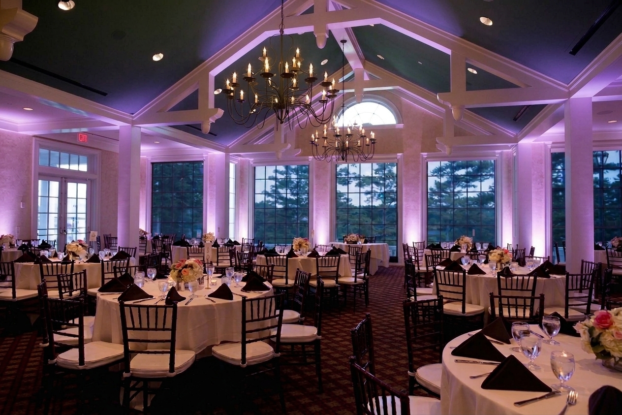 The same reception room washed in lavender uplighting